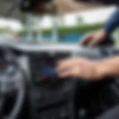 A user installing a car radio into a vehicle