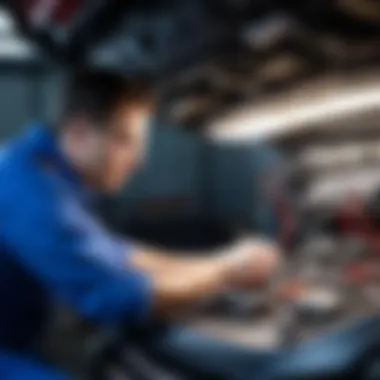 Mechanic examining vehicle wiring under the dashboard