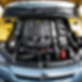 Overview of the Opel Astra H engine compartment highlighting the generator location