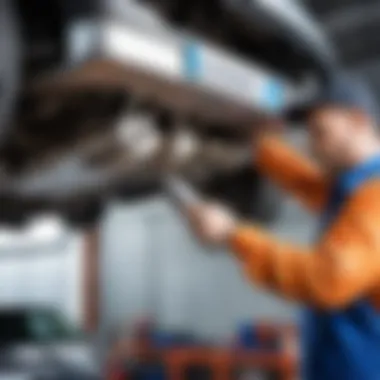 Mechanic inspecting the catalytic converter during vehicle maintenance