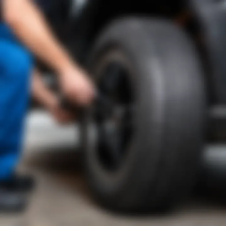 A technician inspecting a tire for wear and pressure